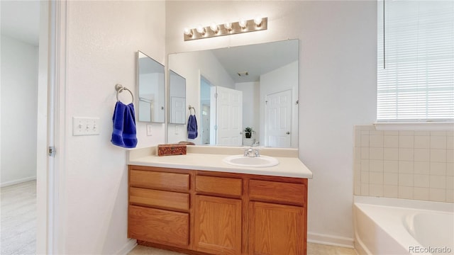 bathroom with a garden tub and vanity