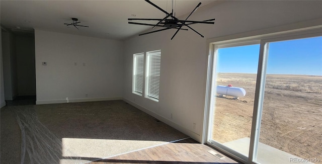 unfurnished room with a wealth of natural light and a notable chandelier