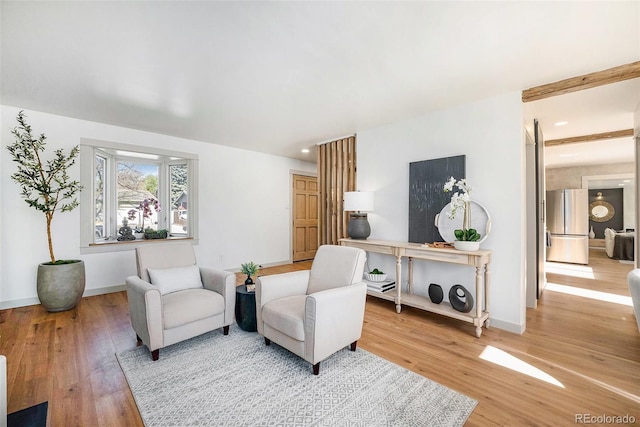 sitting room featuring baseboards and wood finished floors