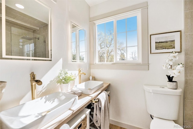 full bath with vanity, toilet, and a shower stall