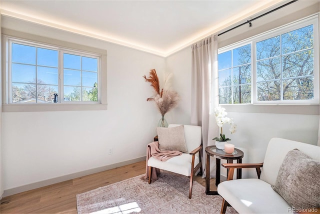 living area with light wood finished floors and baseboards