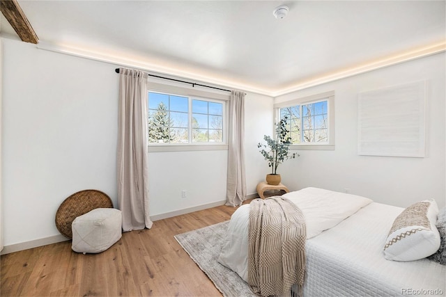bedroom featuring baseboards and light wood-style floors