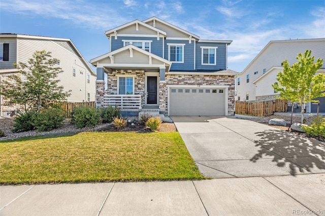 118 N Newcastle Way, Aurora, CO 80018 - craftsman house featuring a garage, concrete driveway, stone siding, and a porch