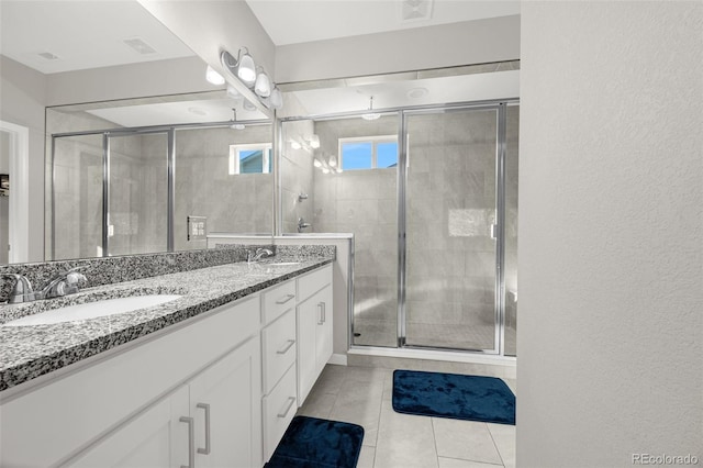118 N Newcastle Way, Aurora, CO 80018 - bathroom featuring a stall shower, double vanity, and tile patterned flooring