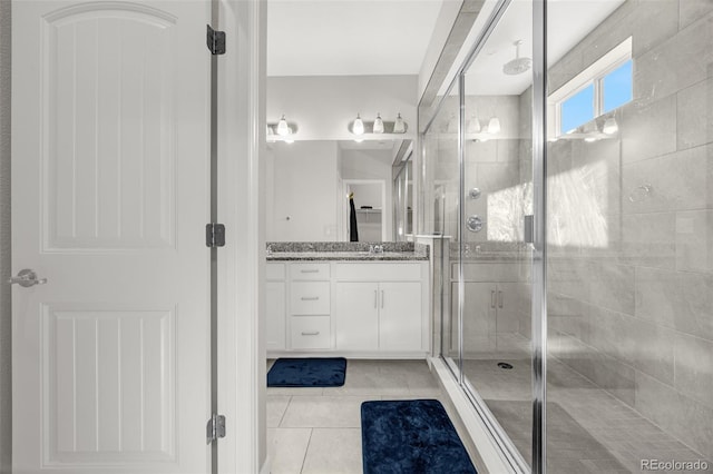 118 N Newcastle Way, Aurora, CO 80018 - full bath with a stall shower, vanity, and tile patterned flooring