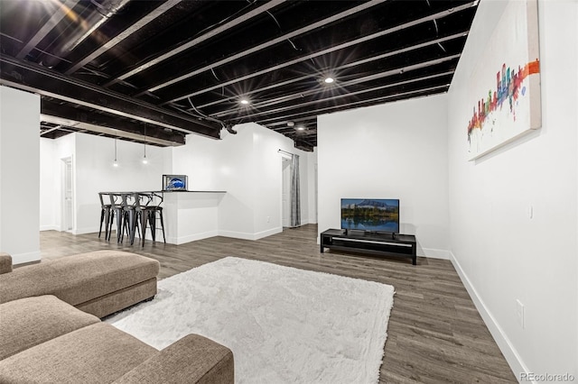 118 N Newcastle Way, Aurora, CO 80018 - living room with wood finished floors, baseboards, and bar