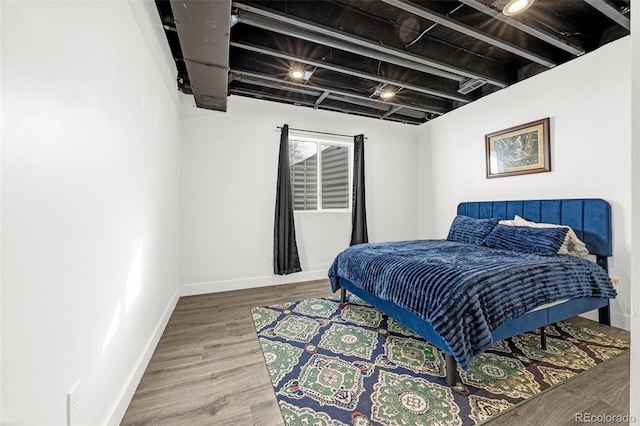118 N Newcastle Way, Aurora, CO 80018 - bedroom with baseboards and wood finished floors