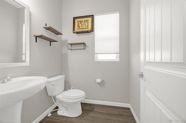 118 N Newcastle Way, Aurora, CO 80018 - bathroom with wood finished floors, toilet, baseboards, and a sink