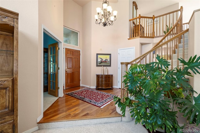 entrance foyer featuring a chandelier, hardwood / wood-style floors, and a high ceiling