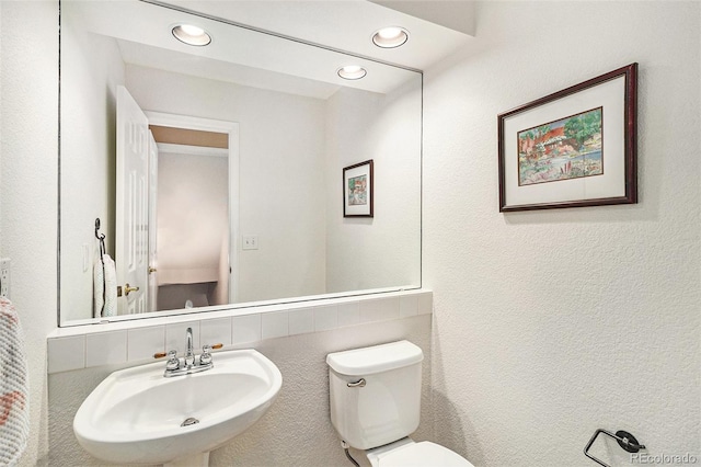 bathroom featuring sink and toilet