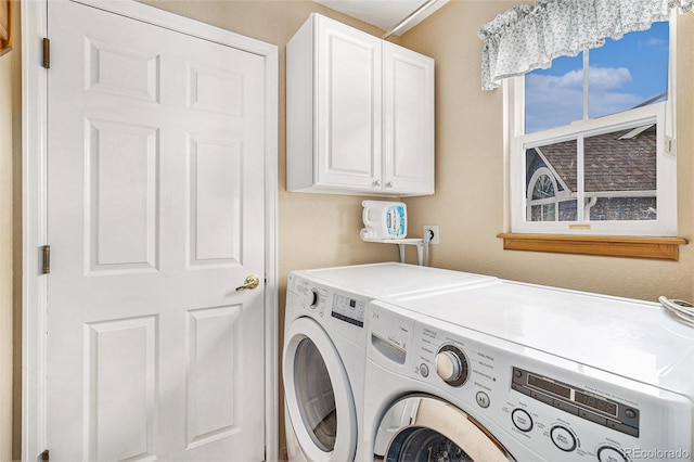 washroom featuring cabinets and independent washer and dryer