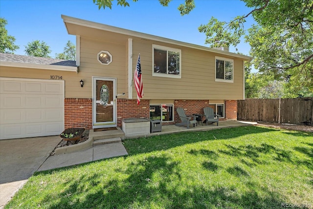 10714 Birch Ct, Thornton, CO 80233 - view of front of house featuring brick siding, an attached garage, and concrete driveway
