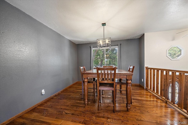 10714 Birch Ct, Thornton, CO 80233 - dining space featuring wood finished floors, a chandelier, and a textured wall