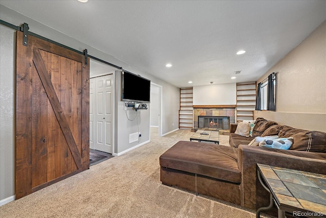 10714 Birch Ct, Thornton, CO 80233 - carpeted living area featuring a barn door, recessed lighting, a tile fireplace, and built in features