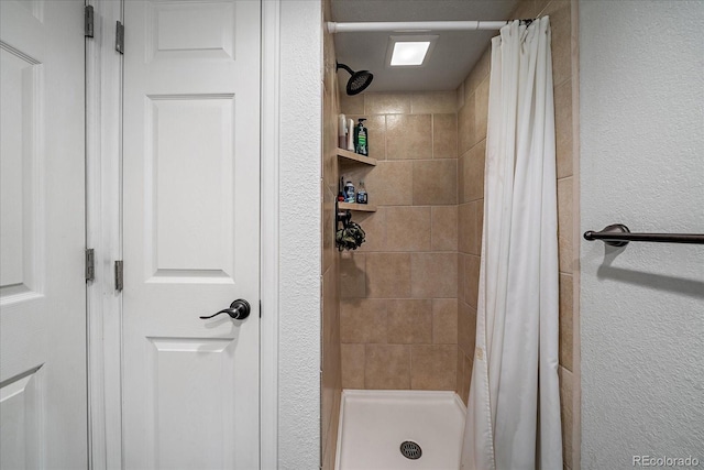 10714 Birch Ct, Thornton, CO 80233 - full bathroom with a tile shower and a textured wall