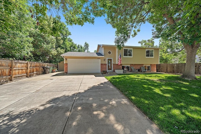 10714 Birch Ct, Thornton, CO 80233 - view of front facade featuring brick siding, an attached garage, and concrete driveway