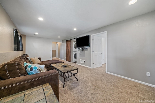 10714 Birch Ct, Thornton, CO 80233 - carpeted living room featuring stacked washer / dryer, recessed lighting, and a barn door