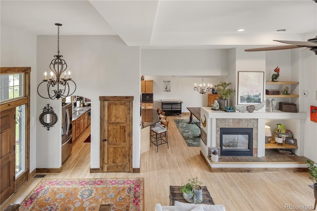 1654 Muirfield Ln, Evergreen, CO 80439 - living area with a chandelier, light wood finished floors, a tile fireplace, a ceiling fan, and recessed lighting
