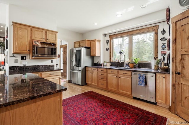 1654 Muirfield Ln, Evergreen, CO 80439 - kitchen with appliances with stainless steel finishes, a sink, light wood-style flooring, dark stone counters, and recessed lighting