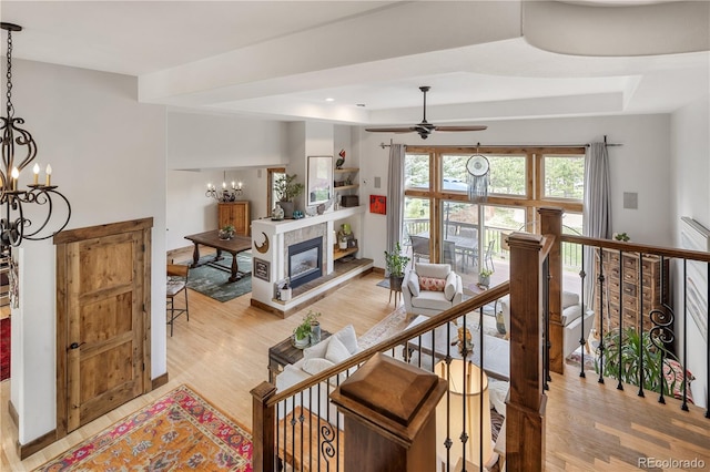 1654 Muirfield Ln, Evergreen, CO 80439 - living room featuring light wood finished floors, a chandelier, and a tray ceiling