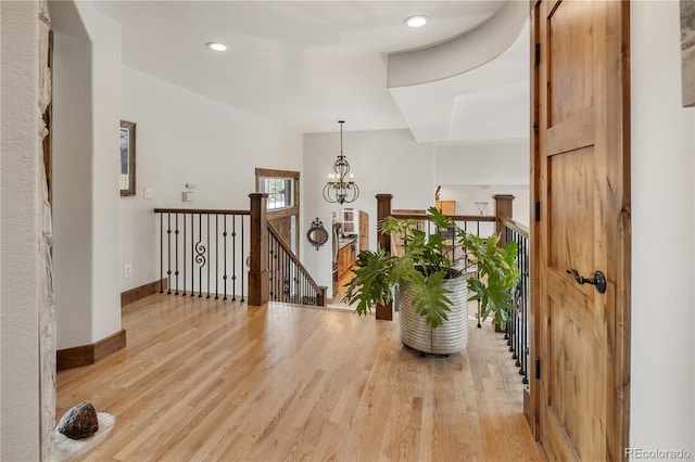 1654 Muirfield Ln, Evergreen, CO 80439 - corridor featuring an upstairs landing, a chandelier, light wood-style flooring, baseboards, and recessed lighting