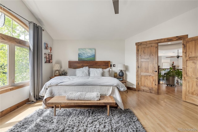 1654 Muirfield Ln, Evergreen, CO 80439 - bedroom with light wood-type flooring, vaulted ceiling, baseboards, and ceiling fan