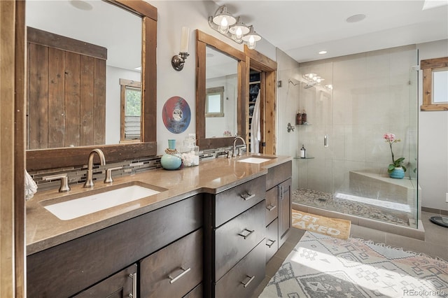 1654 Muirfield Ln, Evergreen, CO 80439 - bathroom featuring double vanity, a stall shower, tile patterned floors, decorative backsplash, and recessed lighting