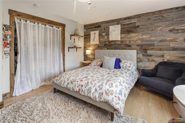 1654 Muirfield Ln, Evergreen, CO 80439 - bedroom featuring wooden walls, an accent wall, and wood finished floors
