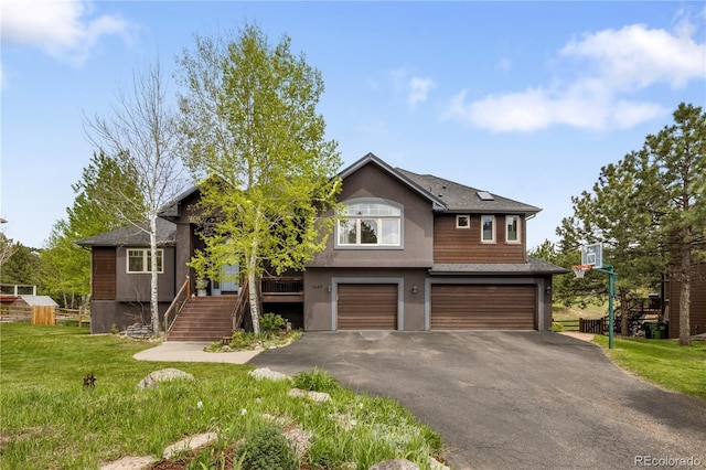1654 Muirfield Ln, Evergreen, CO 80439 - view of front of property with an attached garage, asphalt driveway, a front yard, stairway, and stucco siding