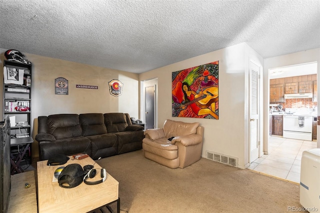 carpeted living room featuring a textured ceiling