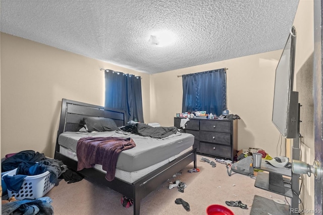 bedroom featuring carpet and a textured ceiling