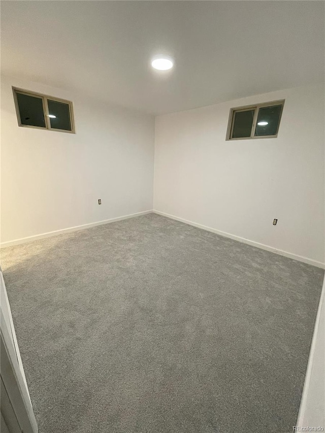 carpeted empty room featuring baseboards and recessed lighting