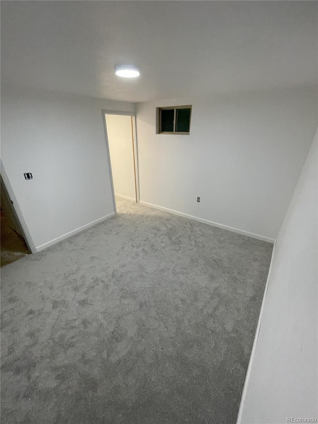 spare room with carpet flooring and baseboards
