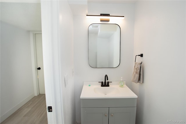 201 Monmouth Ave, Firestone, CO 80520 - bathroom featuring wood finished floors, vanity, and baseboards
