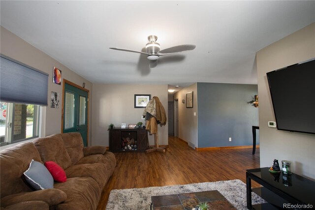 201 Monmouth Ave, Firestone, CO 80520 - living area with wood finished floors, baseboards, and a ceiling fan