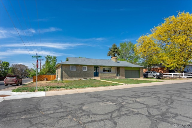 201 Monmouth Ave, Firestone, CO 80520 - single story home featuring an attached garage, brick siding, and a chimney