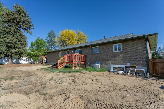 201 Monmouth Ave, Firestone, CO 80520 - back of house featuring a wooden deck, brick siding, and central AC unit