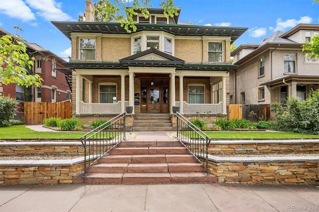 1437 Columbine St, Denver, CO 80206 - view of front of home with covered porch, brick siding, and stairway