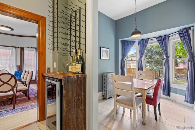 1437 Columbine St, Denver, CO 80206 - dining area with beverage cooler, radiator heating unit, baseboards, and tile patterned flooring