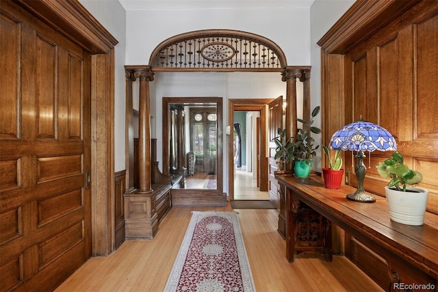 1437 Columbine St, Denver, CO 80206 - entrance foyer featuring light wood-type flooring, a wainscoted wall, and decorative columns