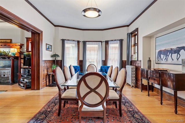 1437 Columbine St, Denver, CO 80206 - dining space with light wood-style flooring, a wainscoted wall, and ornamental molding