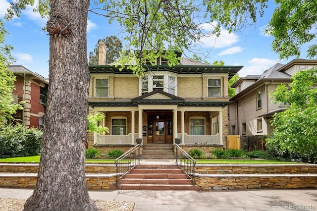 1437 Columbine St, Denver, CO 80206 - view of front of home featuring covered porch, brick siding, stairway, and a chimney