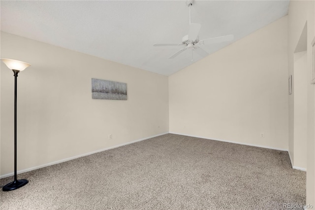 carpeted spare room with a ceiling fan, lofted ceiling, and baseboards