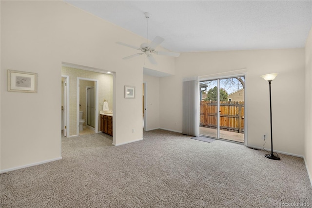 interior space featuring high vaulted ceiling, baseboards, and a ceiling fan