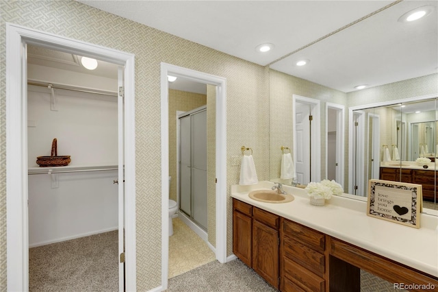 full bathroom featuring a stall shower, vanity, toilet, and recessed lighting