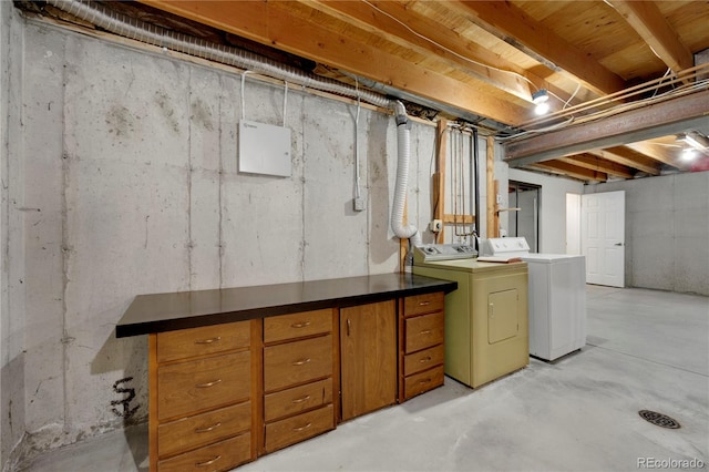 unfinished below grade area featuring independent washer and dryer