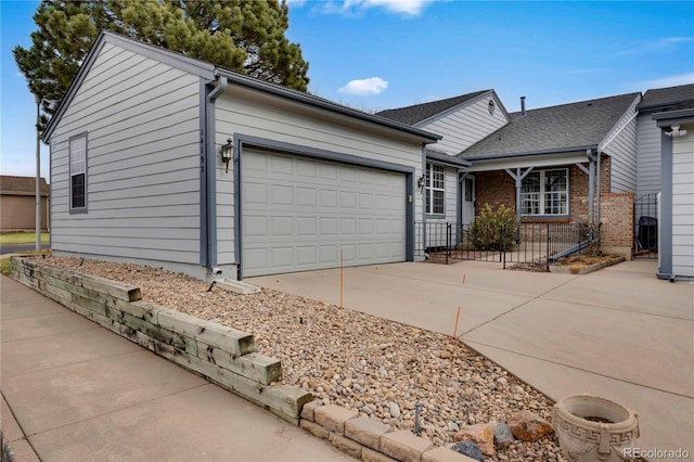 ranch-style home featuring an attached garage, driveway, and brick siding