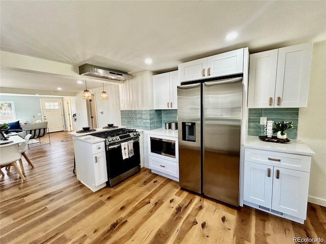 601 W Layton Ave, Englewood, CO 80110 - kitchen with stainless steel appliances, white cabinetry, light countertops, light wood-style floors, and decorative backsplash