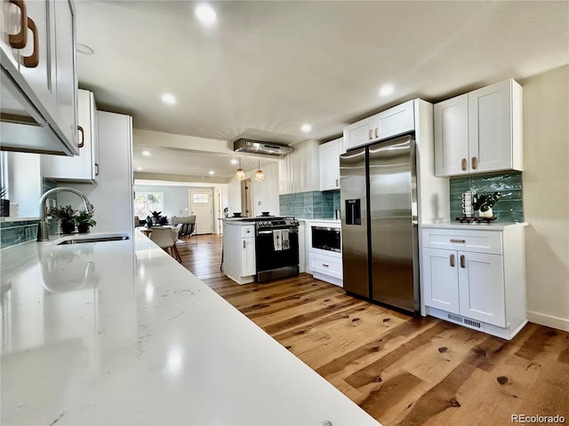 601 W Layton Ave, Englewood, CO 80110 - kitchen featuring stainless steel refrigerator with ice dispenser, dishwashing machine, built in microwave, white cabinetry, and recessed lighting