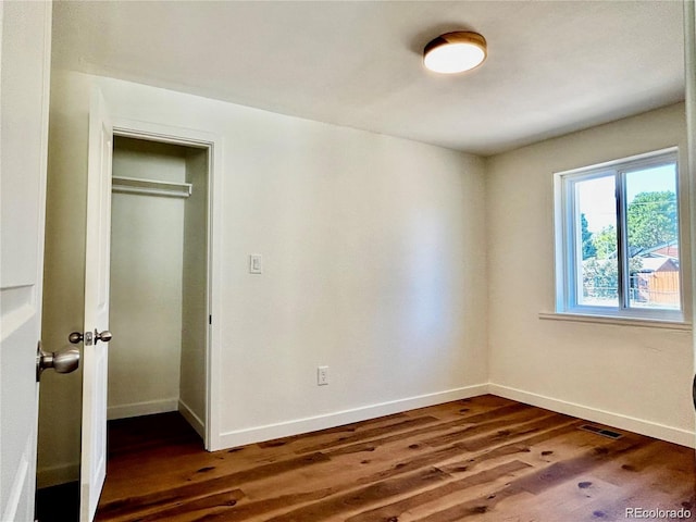 601 W Layton Ave, Englewood, CO 80110 - unfurnished bedroom with dark wood finished floors and a closet